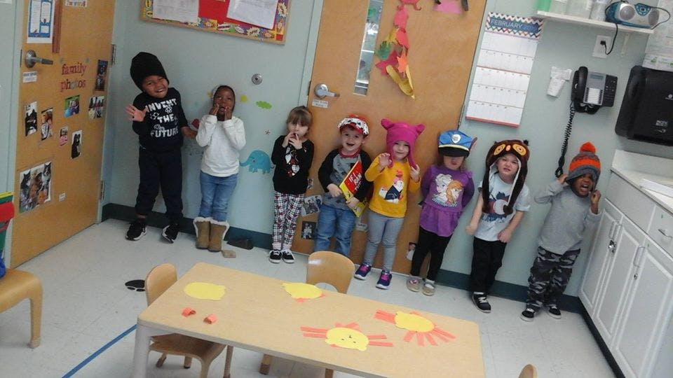 Group of children standing in a classroom