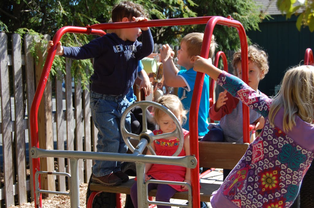 Children playing on a red playground structure