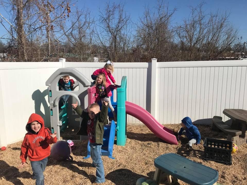 Children playing on a playground structure with a slide