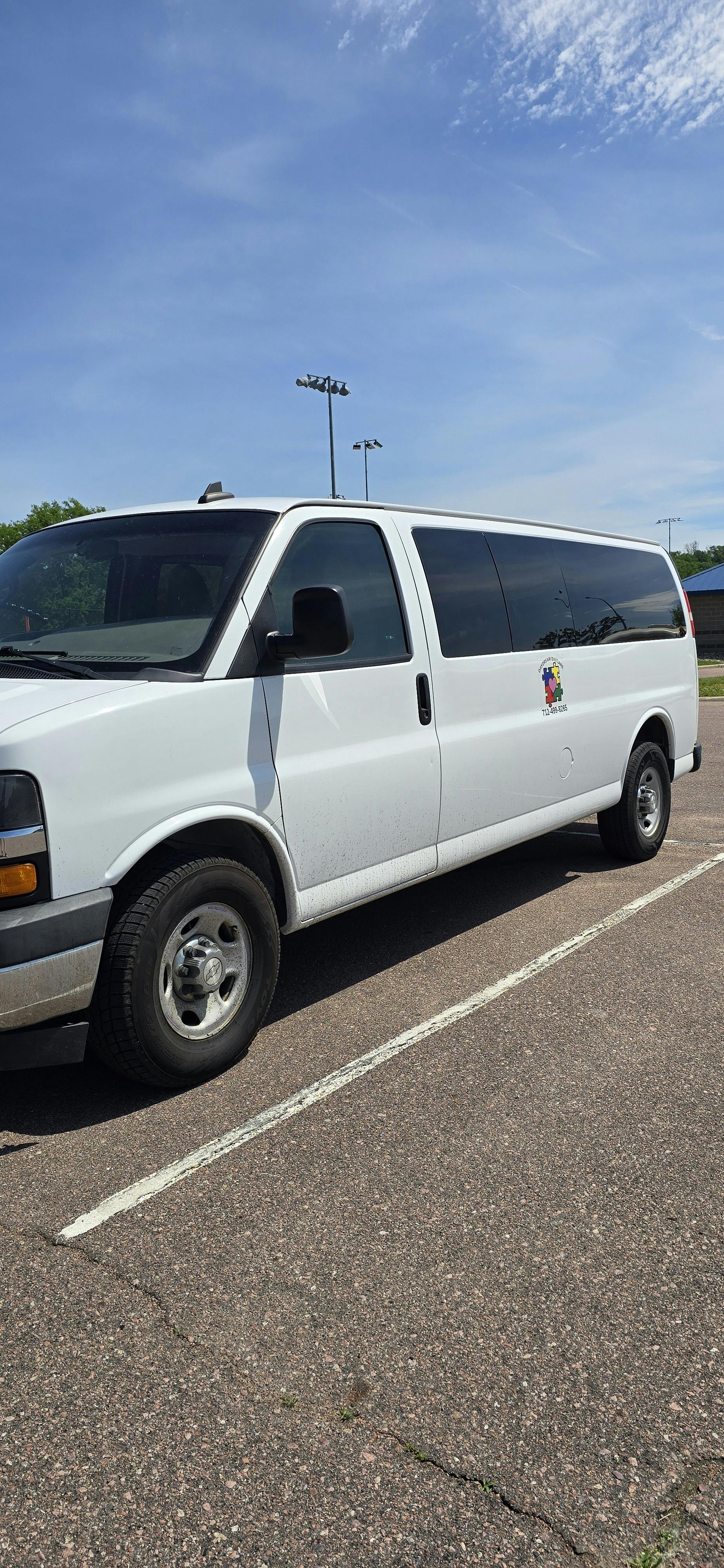 White van with tinted windows parked on asphalt