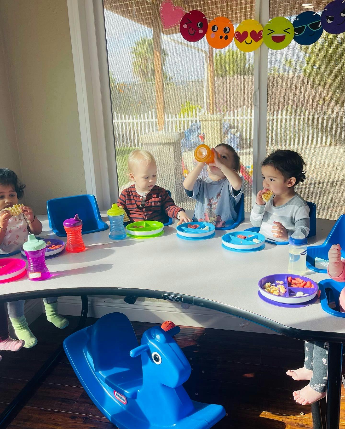 Three children eating at a table