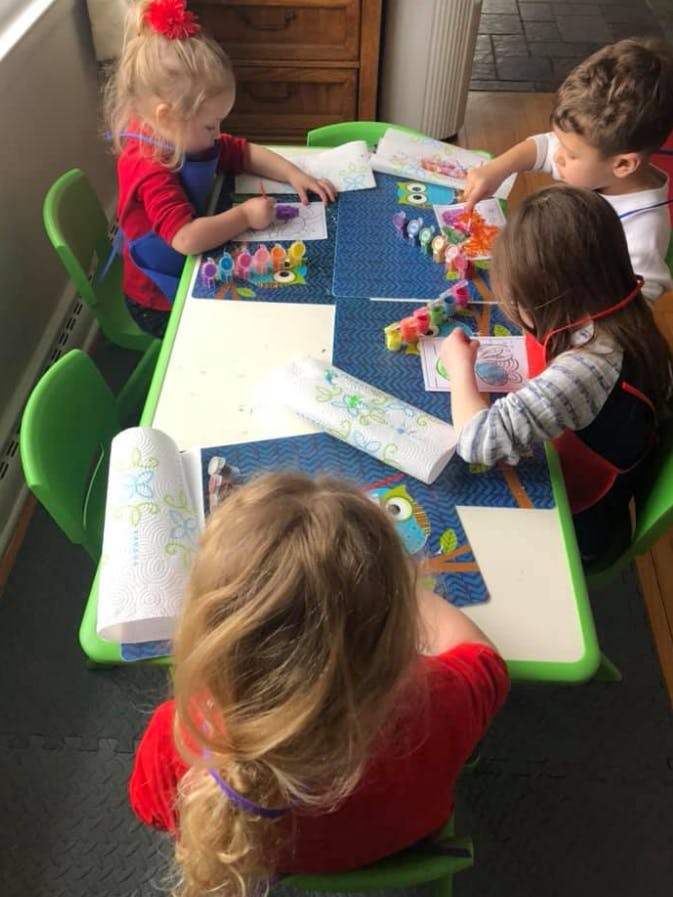 Children drawing and crafting at a table