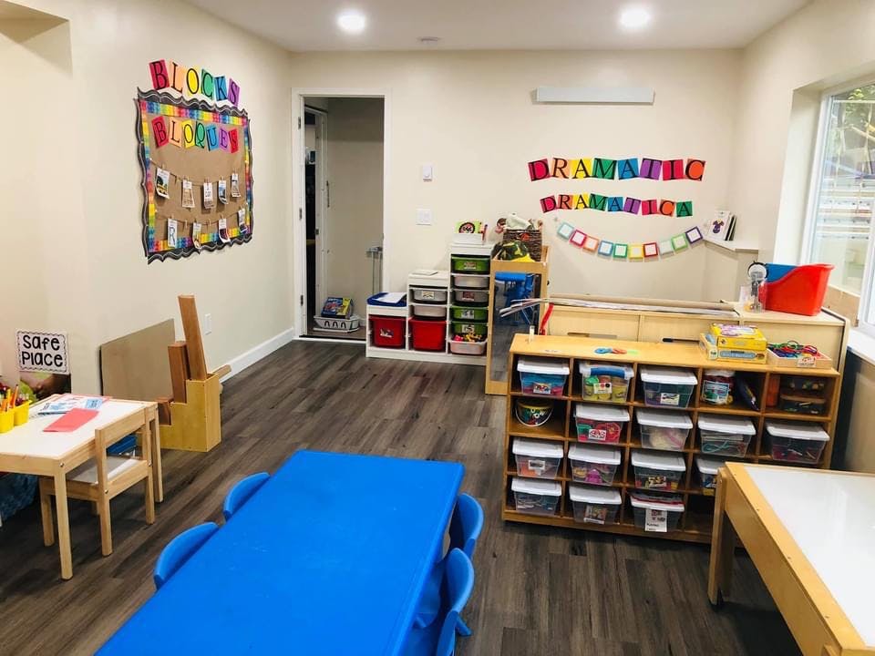 Classroom with tables, chairs, and storage shelves