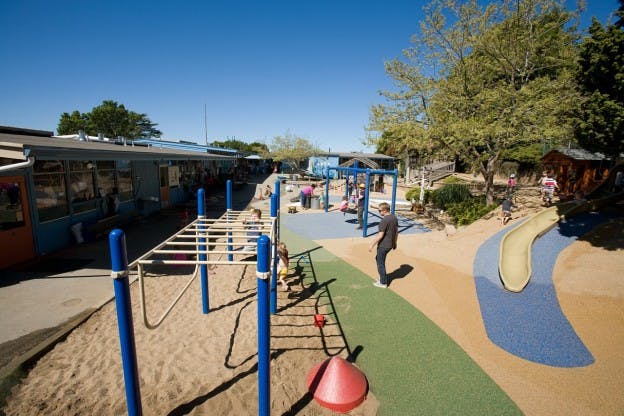 Playground with monkey bars, slide, and people