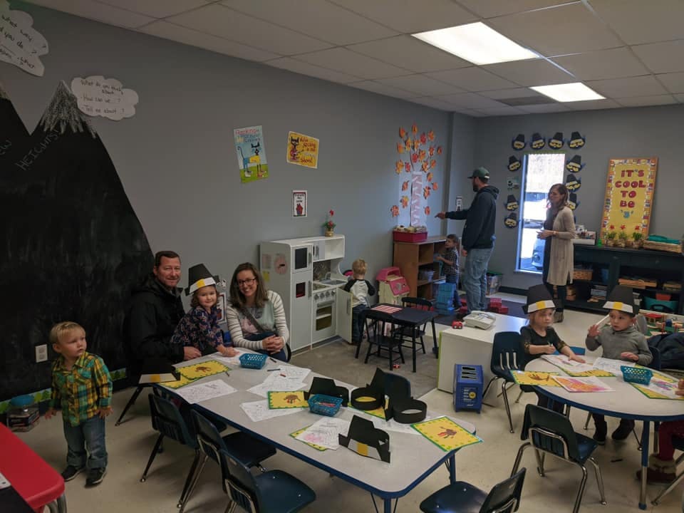 People and children in a classroom