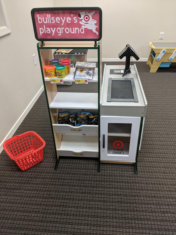 Toy grocery store display with "Bullseye's Playground" sign and checkout counter