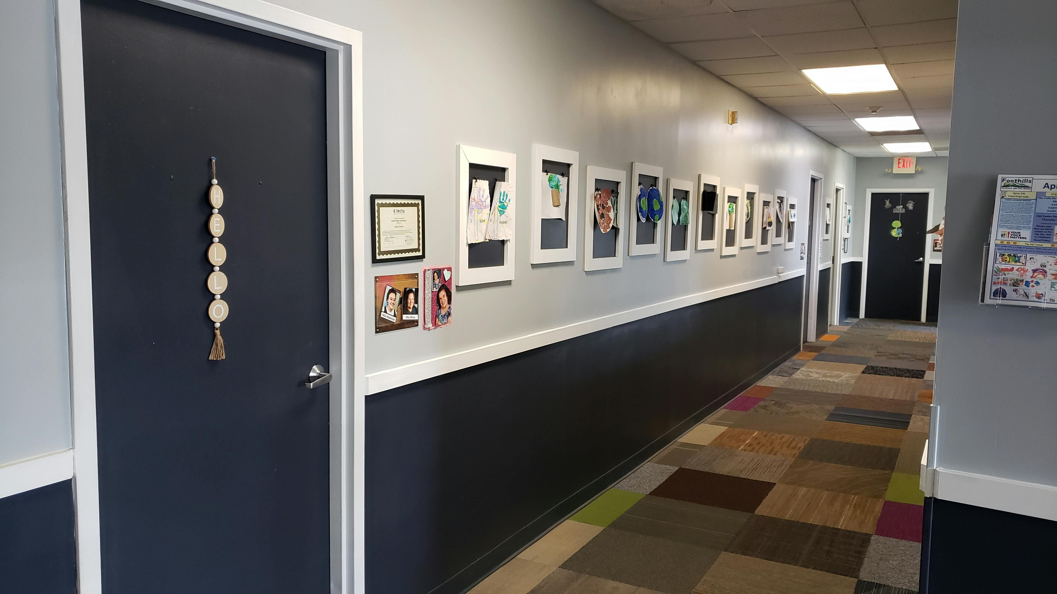 Hallway with framed artwork on the wall