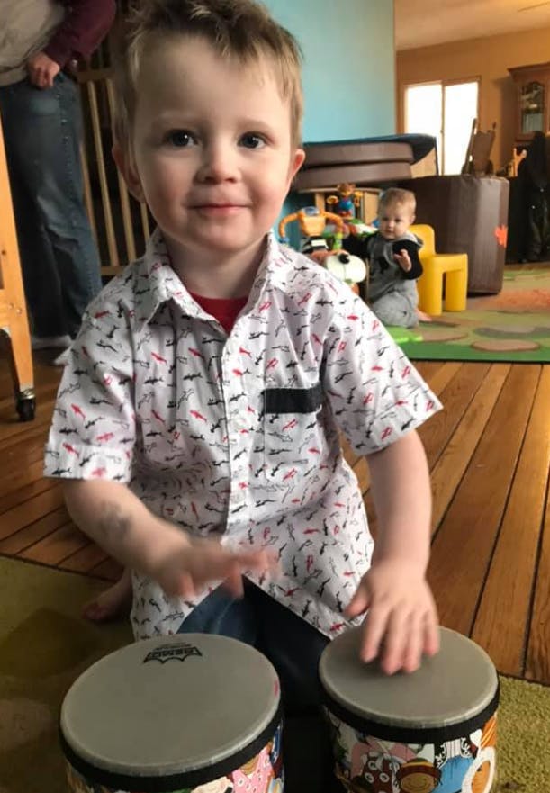 Child playing bongo drums