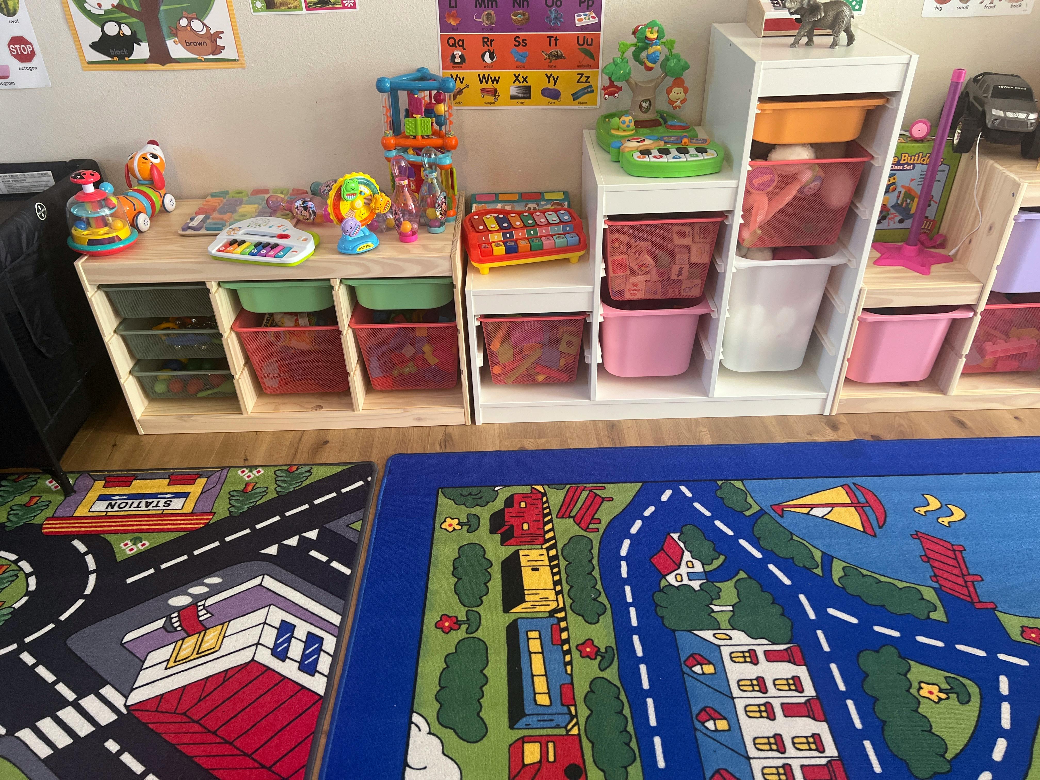 Playroom with toy storage shelves and two road map play mats