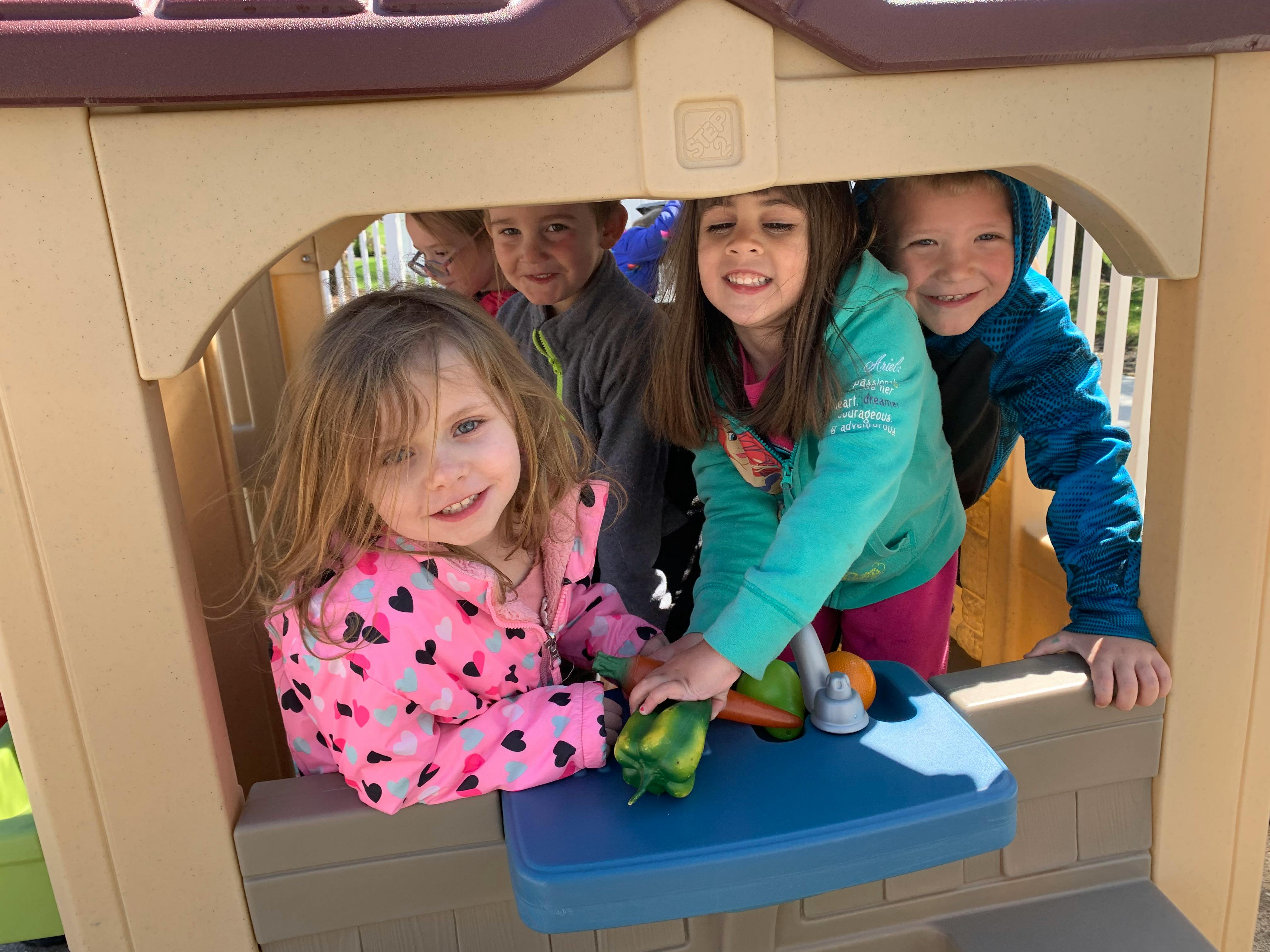 Children playing in a playhouse