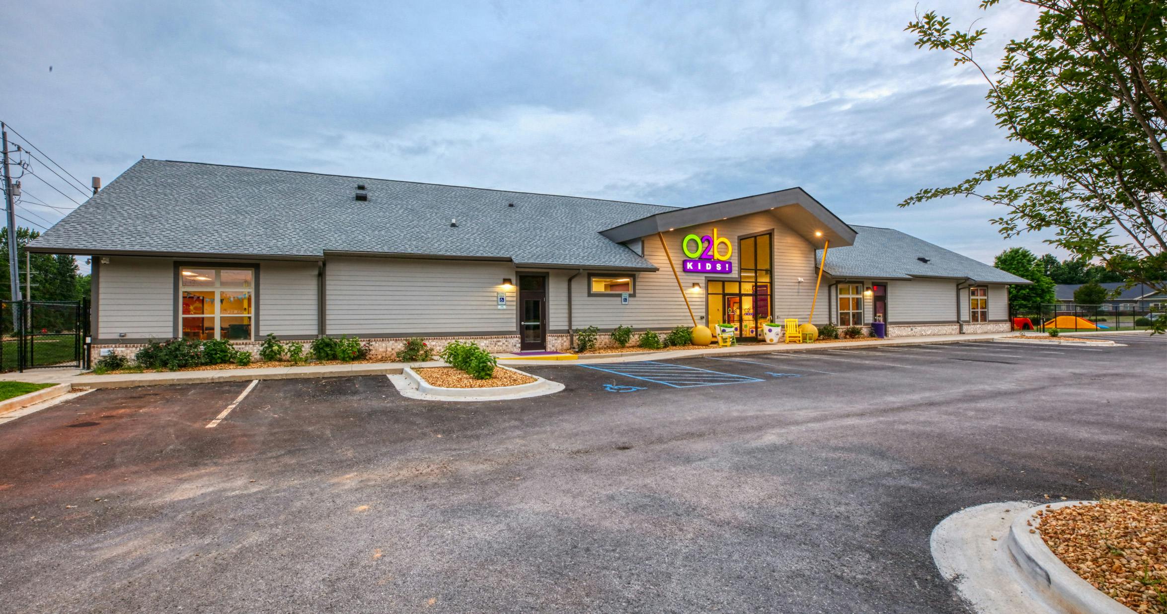 Exterior of a modern building with a sign that reads "o2b kids!"