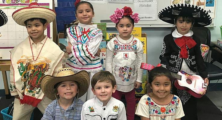 Six children in traditional Mexican clothing