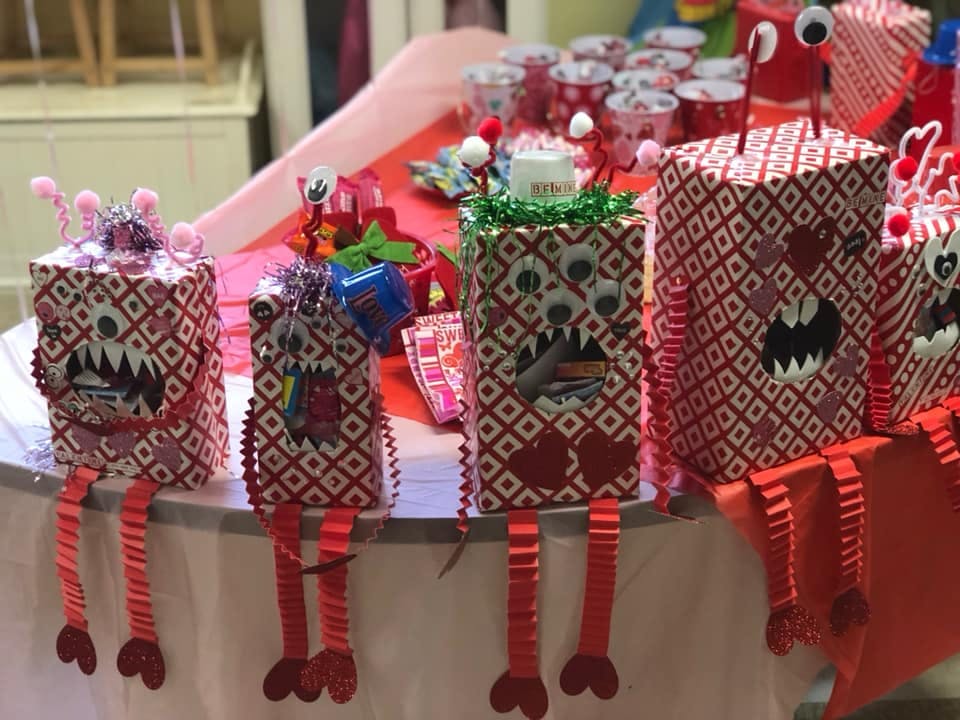 Several monster-themed gift boxes with red and white patterns