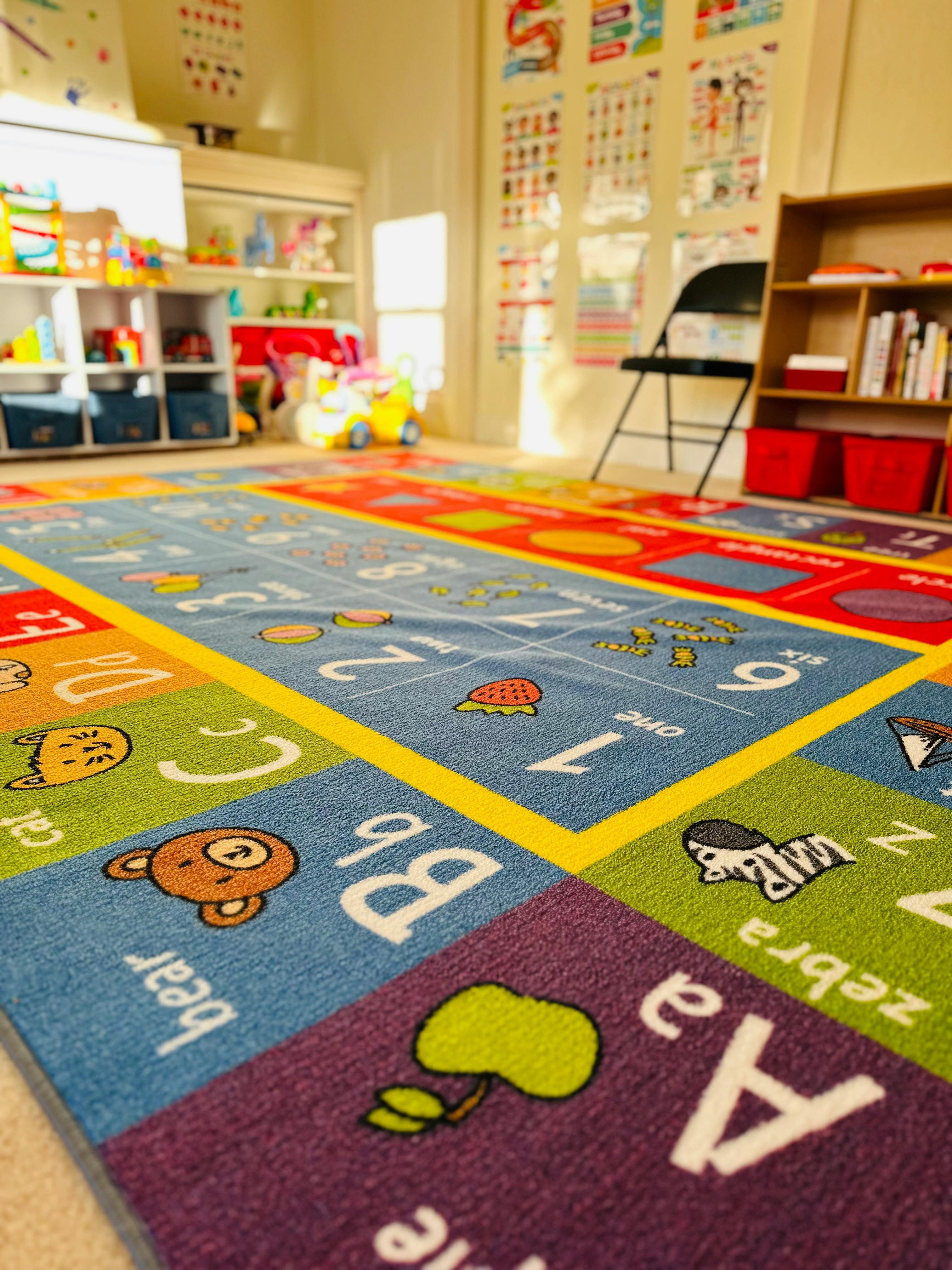 Colorful alphabet and number rug in a classroom