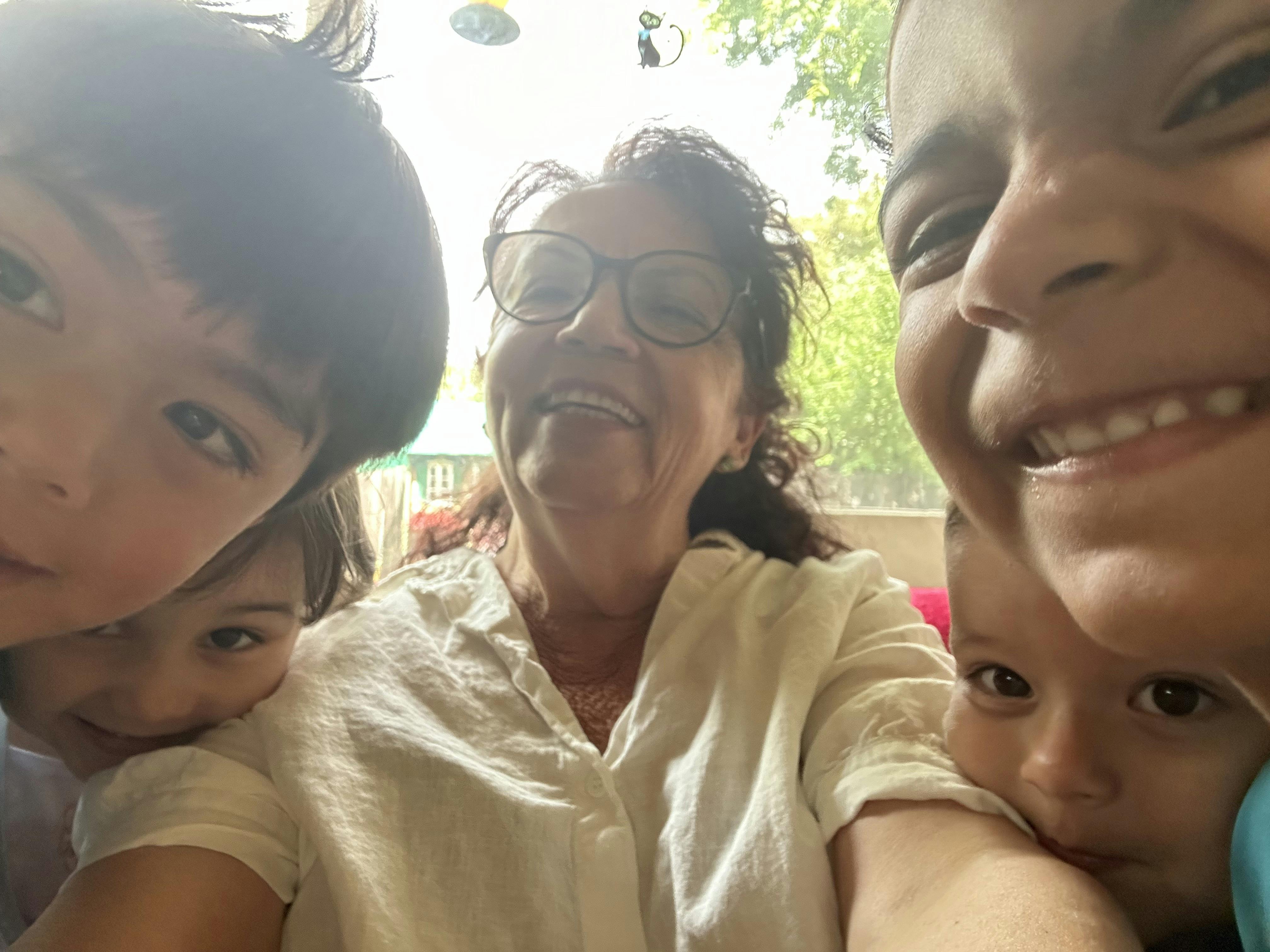 Adult and three children taking a selfie