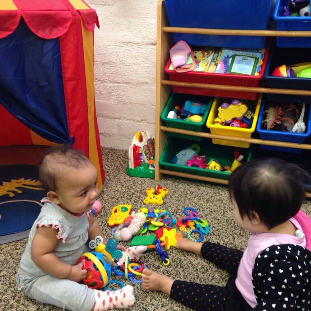 Two children playing with toys on the floor