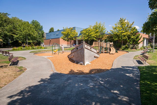 Playground with a boat-shaped structure and slides