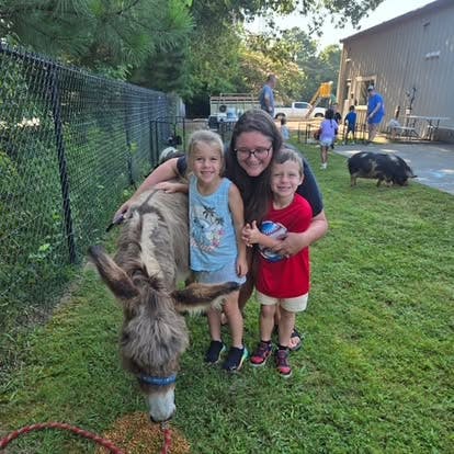 Adult and two children with a donkey