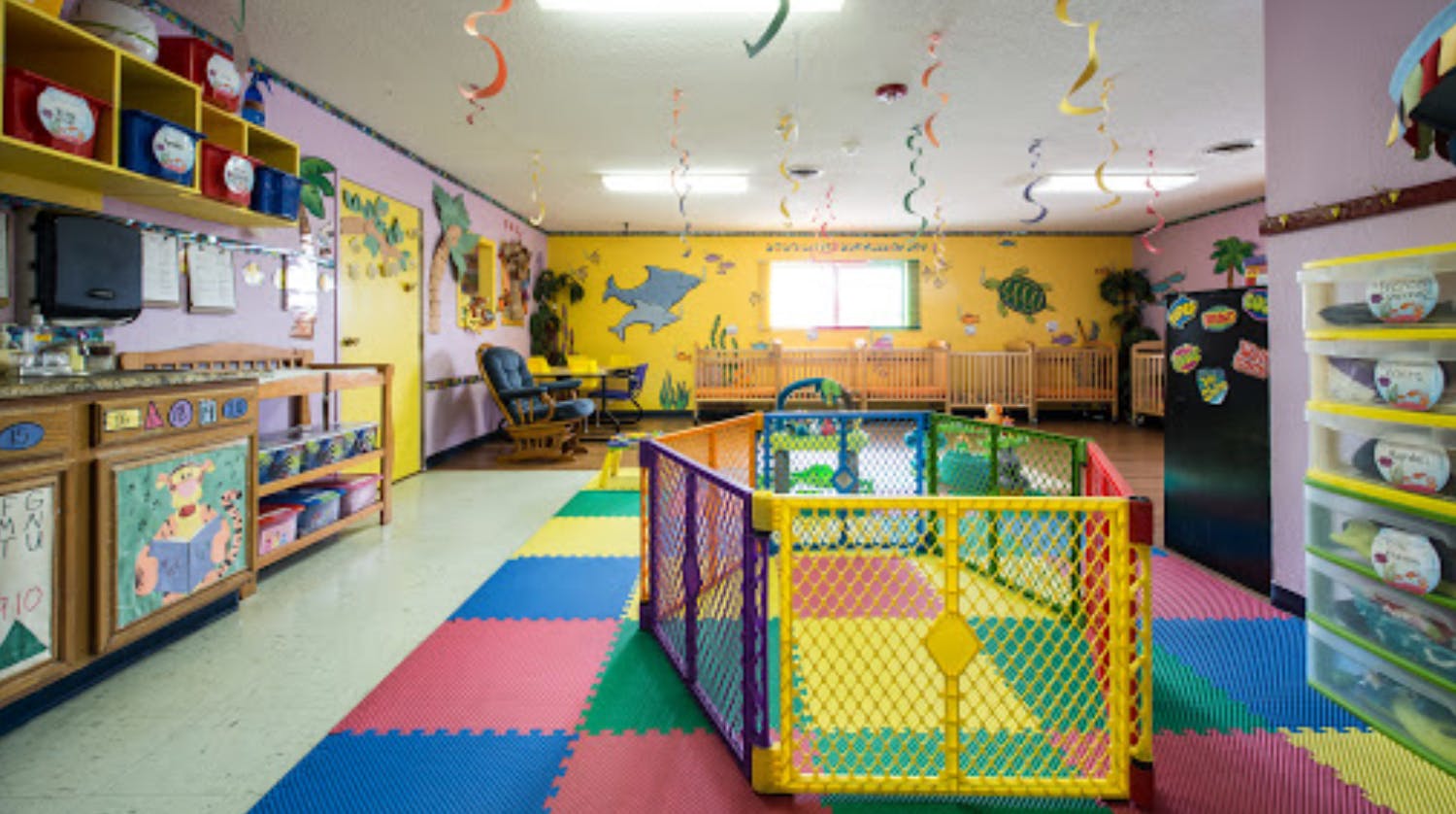 Playroom with colorful floor mats and a playpen