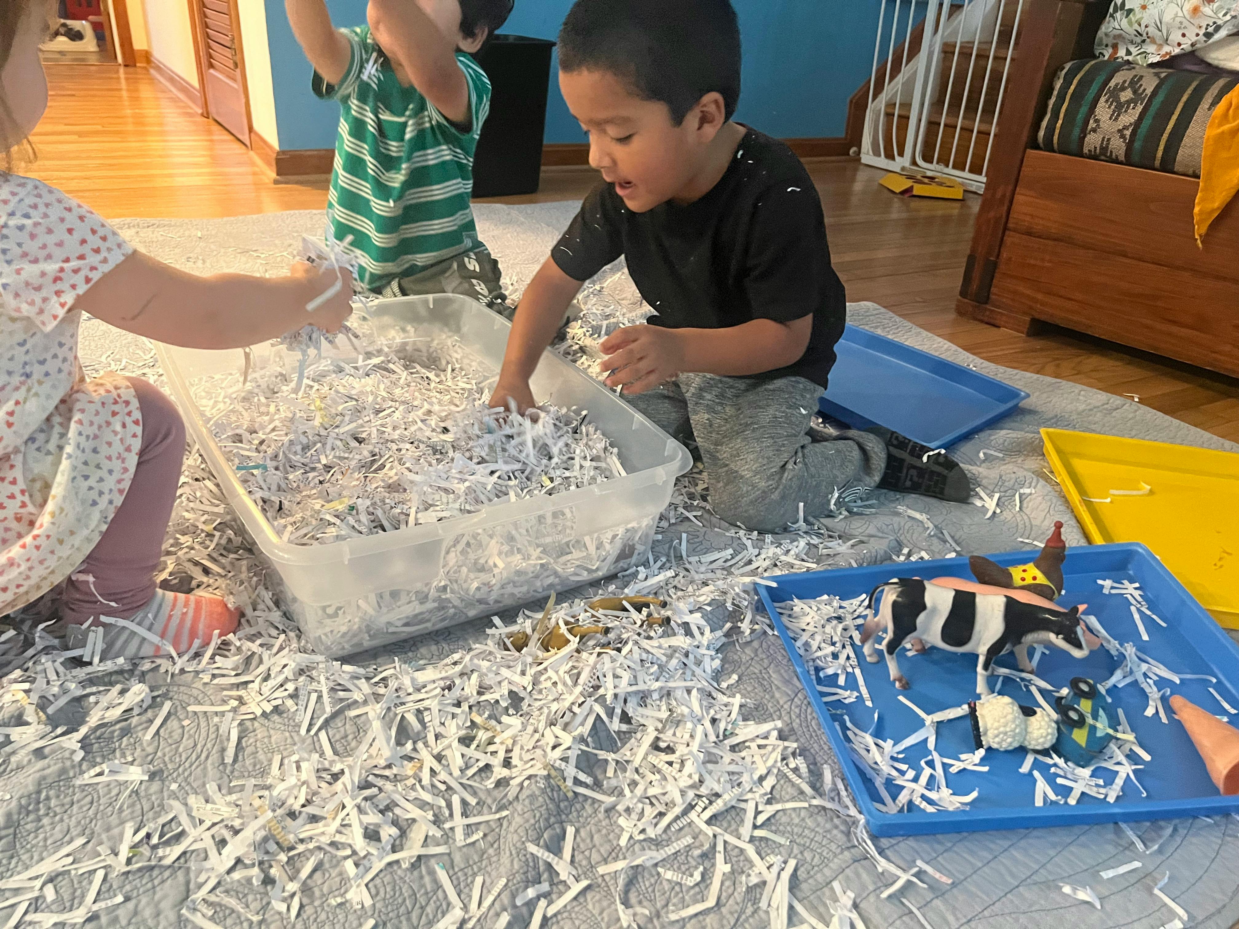 Children playing with shredded paper