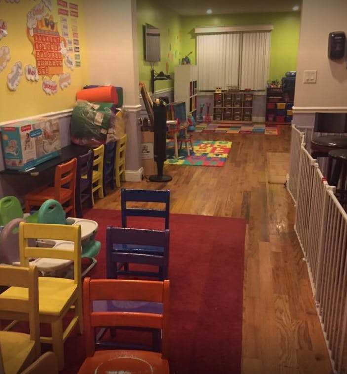 Childcare room with small chairs and play mats