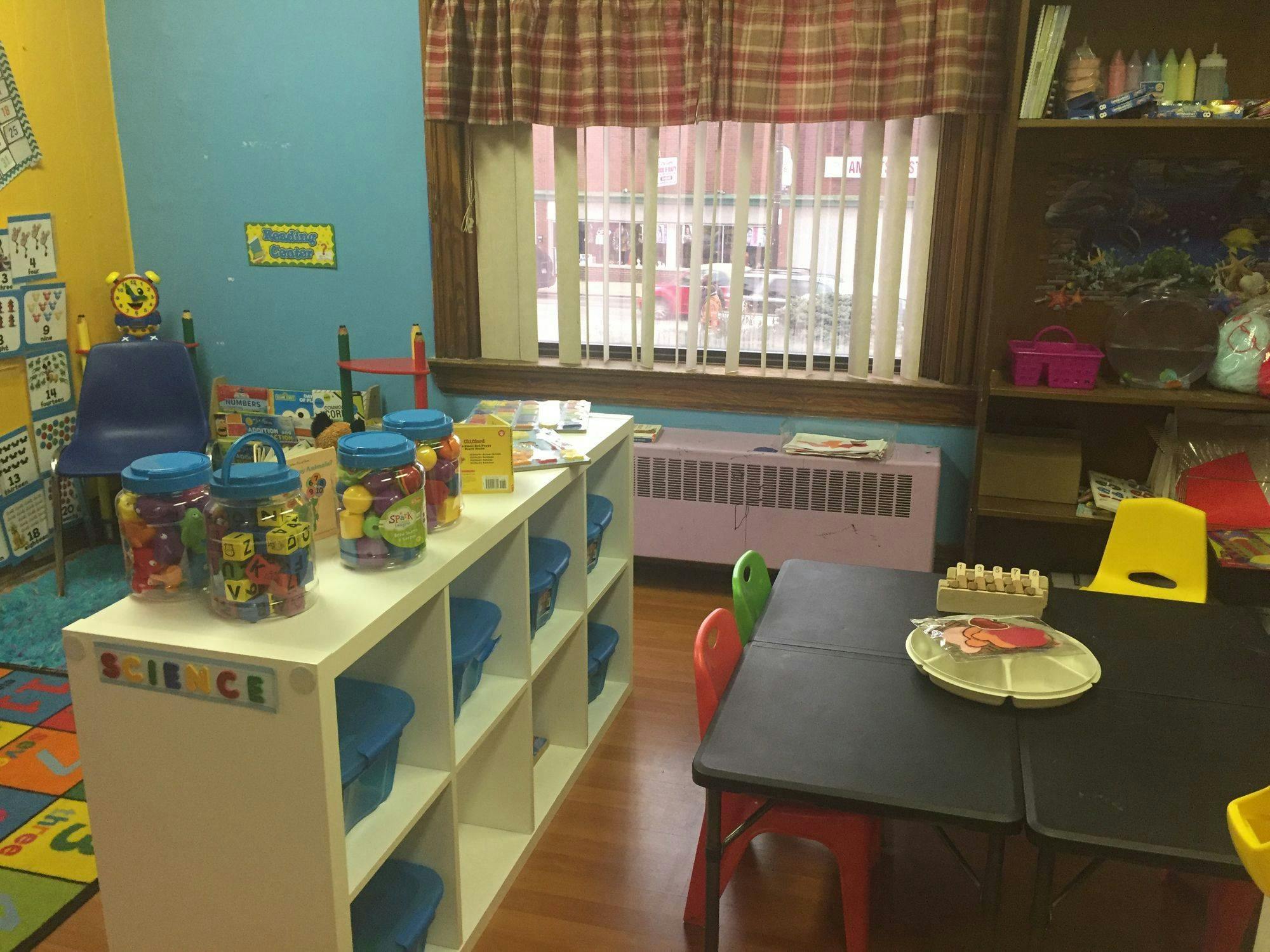 Classroom with shelves of toys, tables, and chairs
