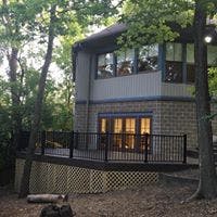 House with a deck surrounded by trees