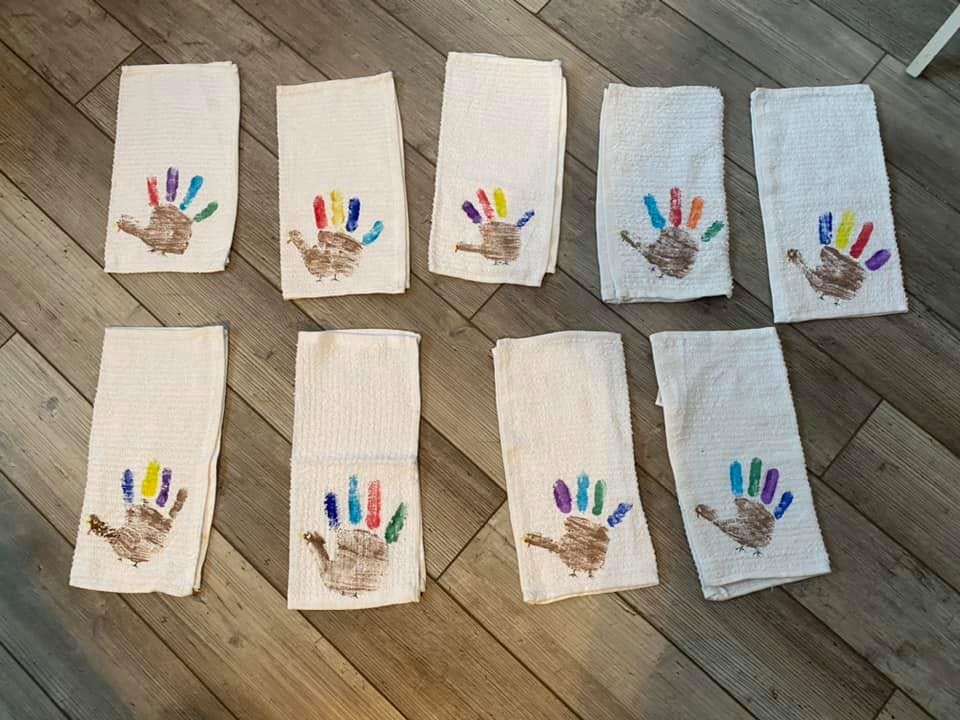 White towels with colorful handprint turkey crafts