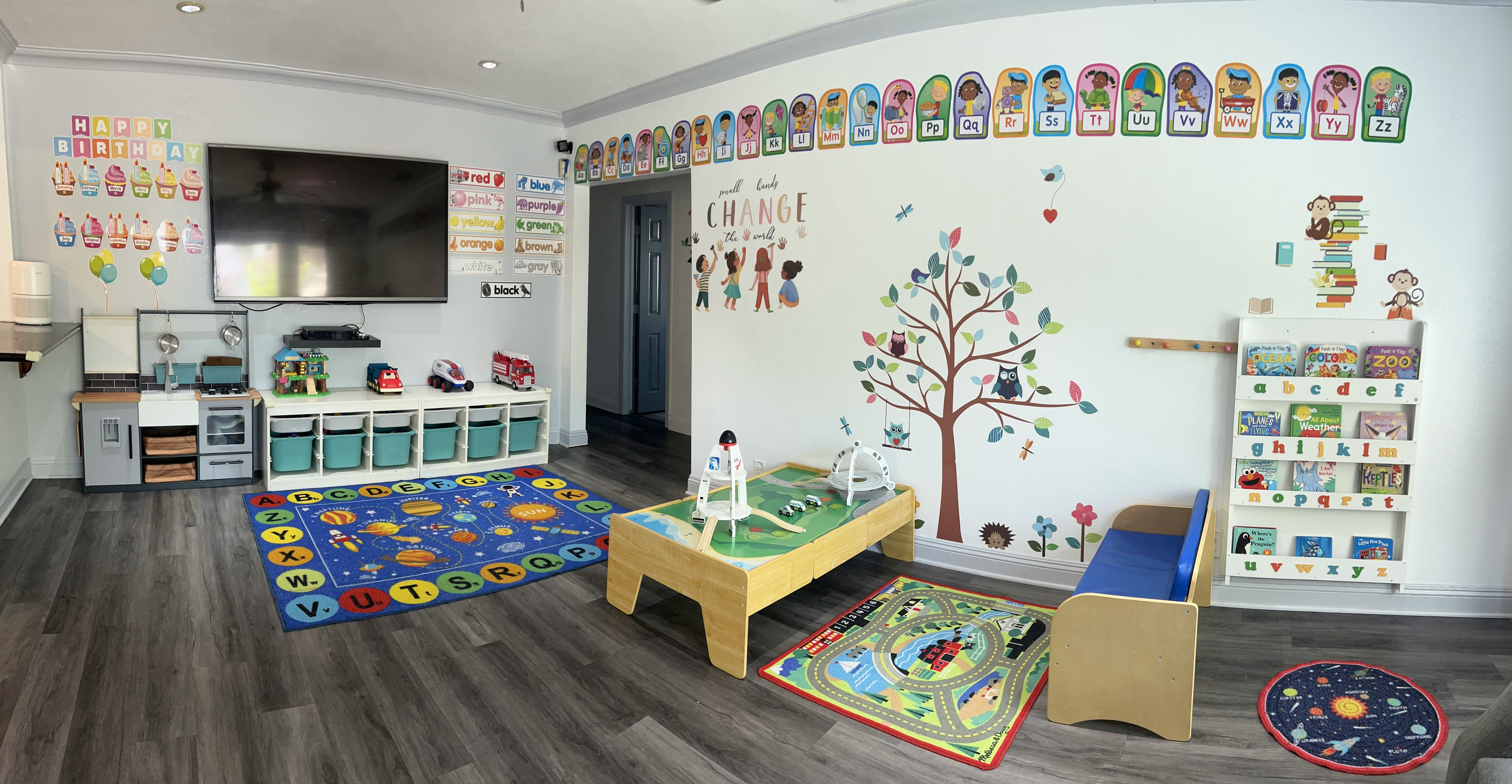 Playroom with toys, rugs, and wall decorations