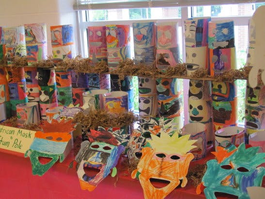 Colorful paper masks and totem pole art display