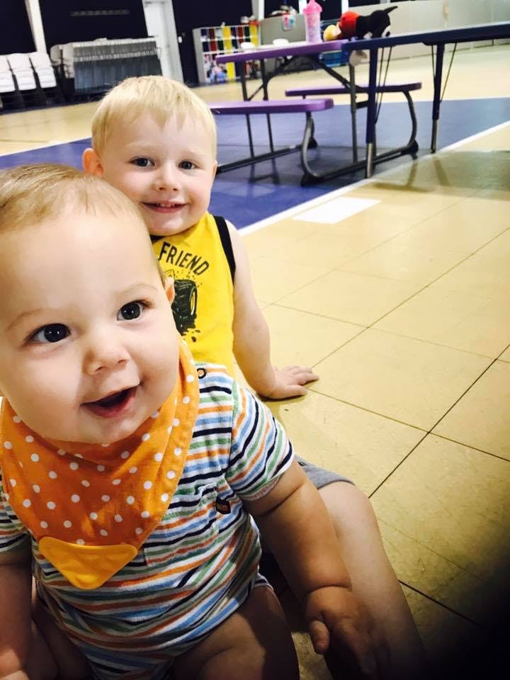 Two children sitting on a floor