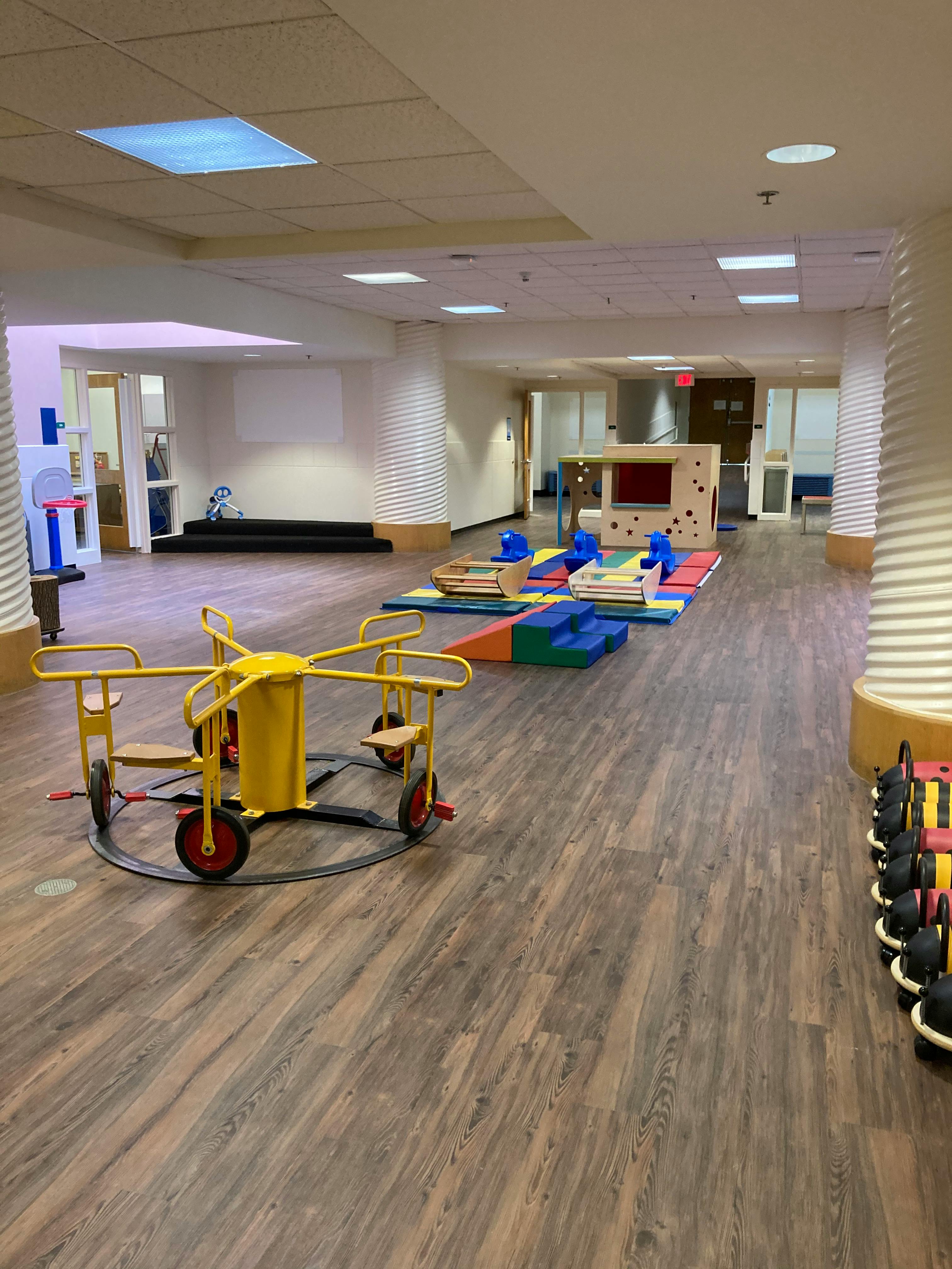 Children's indoor playground with play structures and a merry-go-round