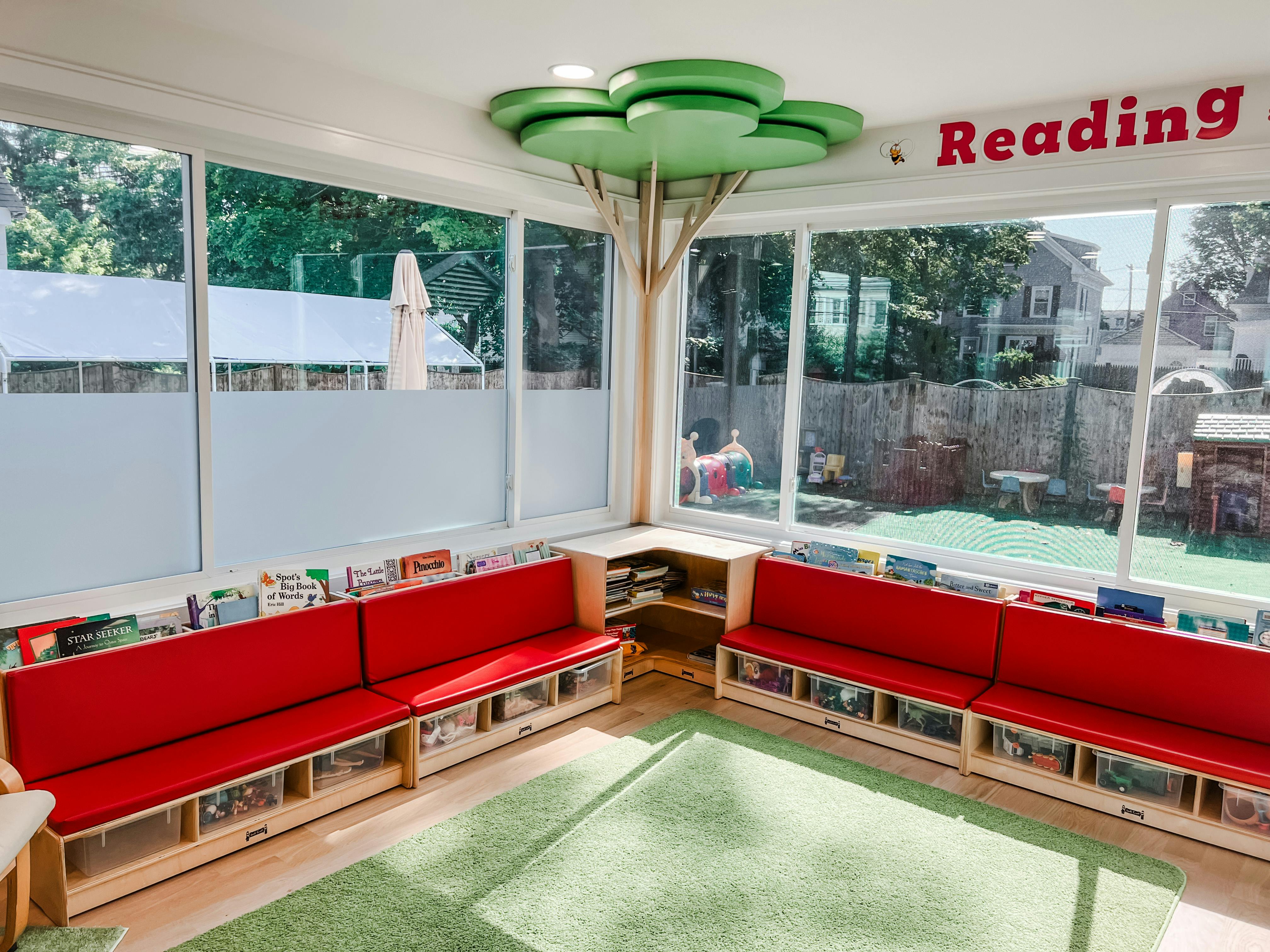 Reading nook with red benches and a tree-like structure