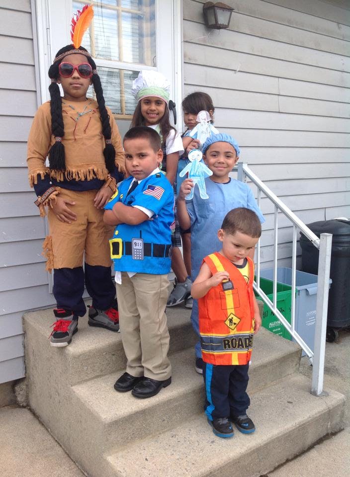 Children in costumes standing on steps