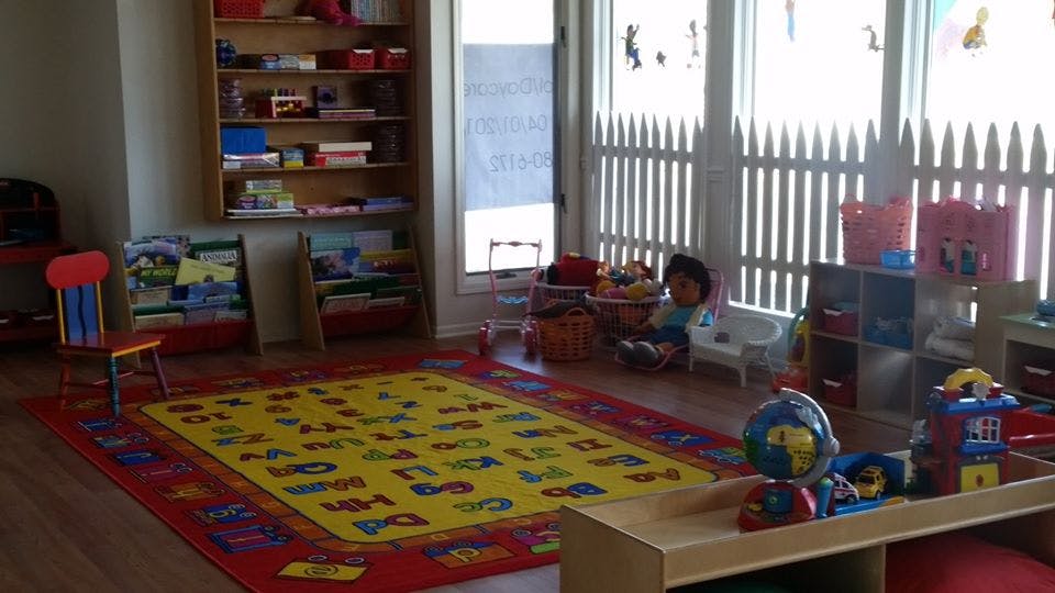 Playroom with alphabet rug and toys