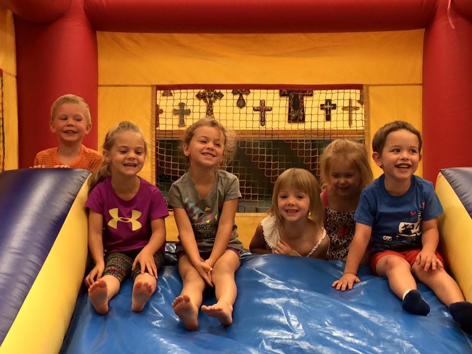 Group of children sitting on an inflatable slide