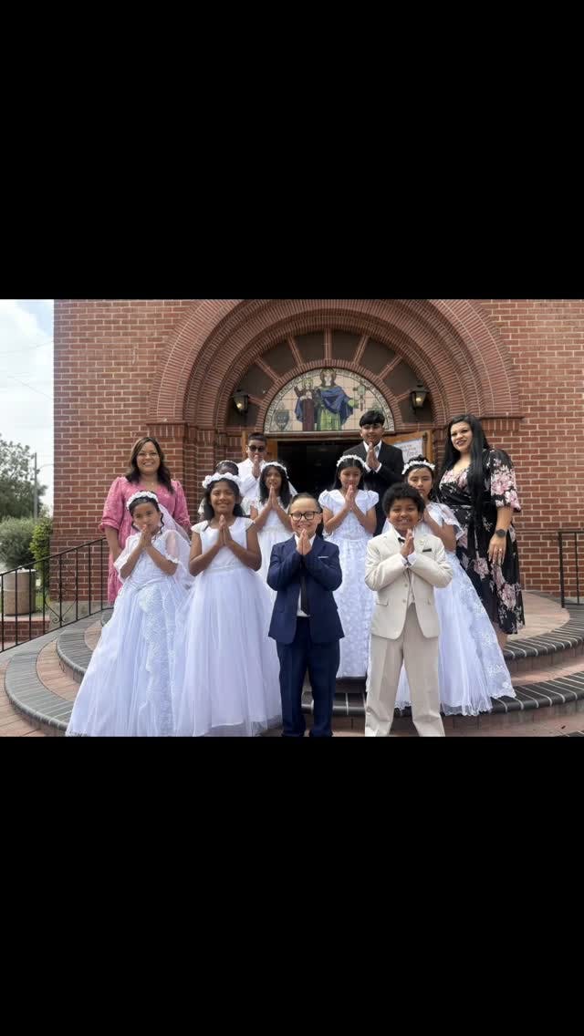 Group of children and adults posing on church steps