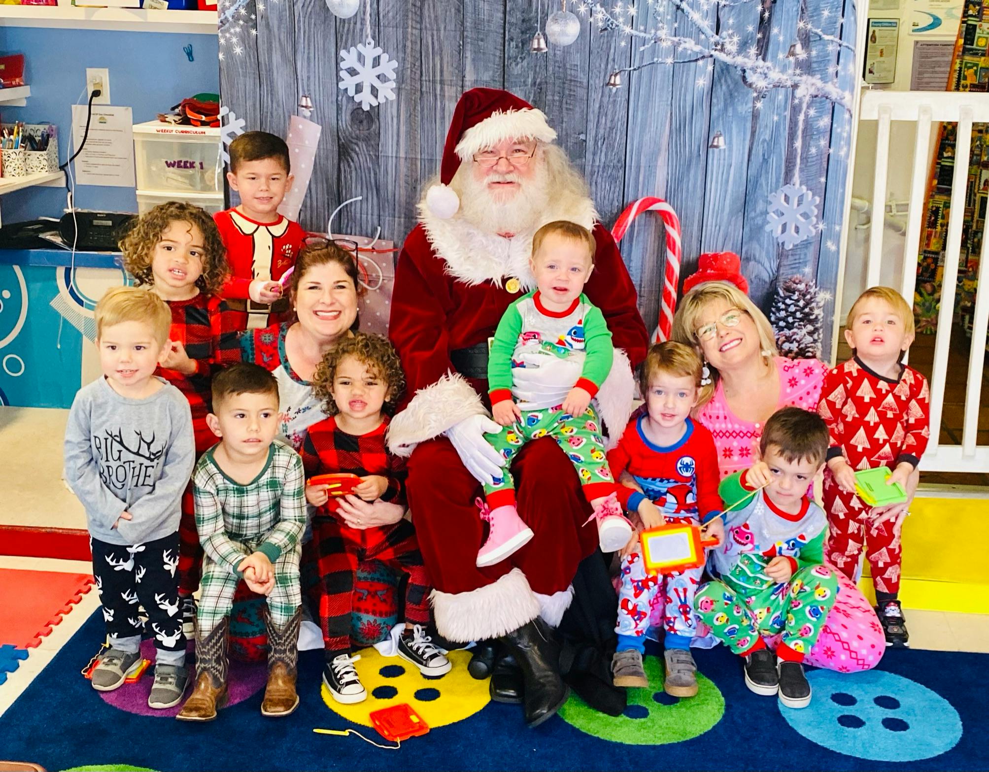 Santa Claus with adults and children in pajamas