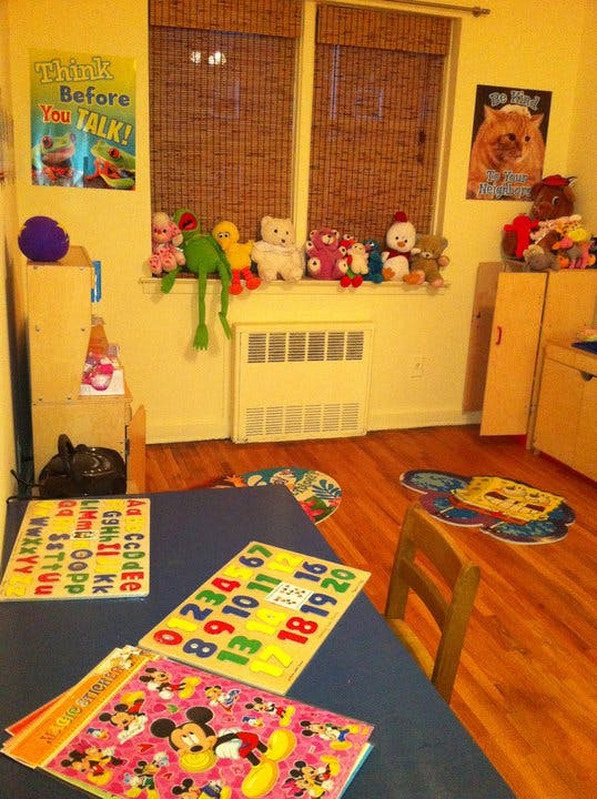 Classroom with stuffed animals on a window sill and puzzles on a table