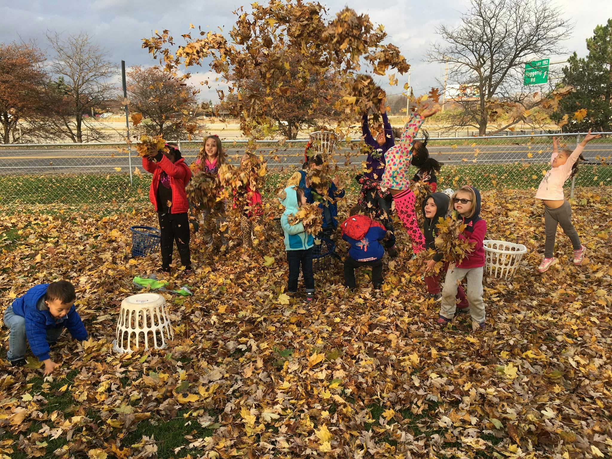 Children playing in a pile of autumn leaves