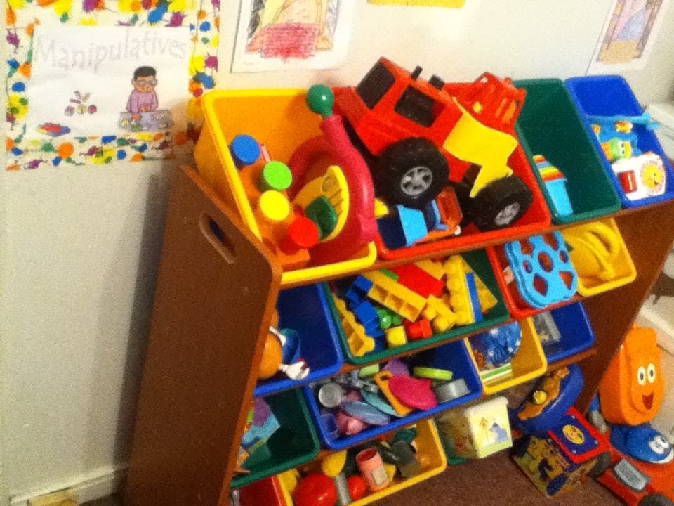 Toy organizer with colorful bins filled with various toys