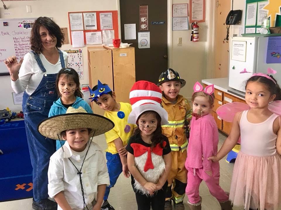 Adult and children in costumes posing together