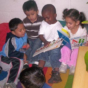Four children reading books together