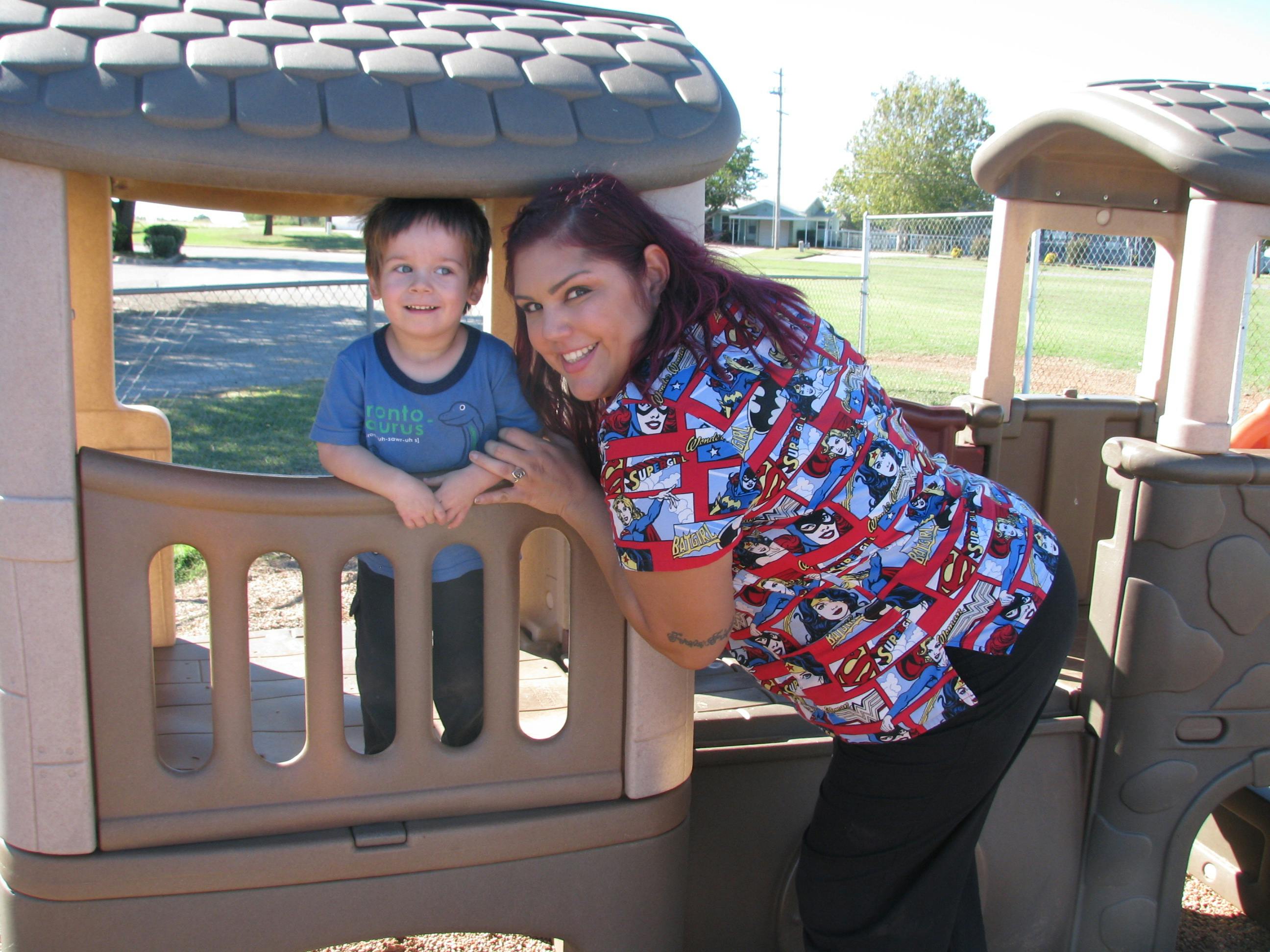 Person and child in a playhouse