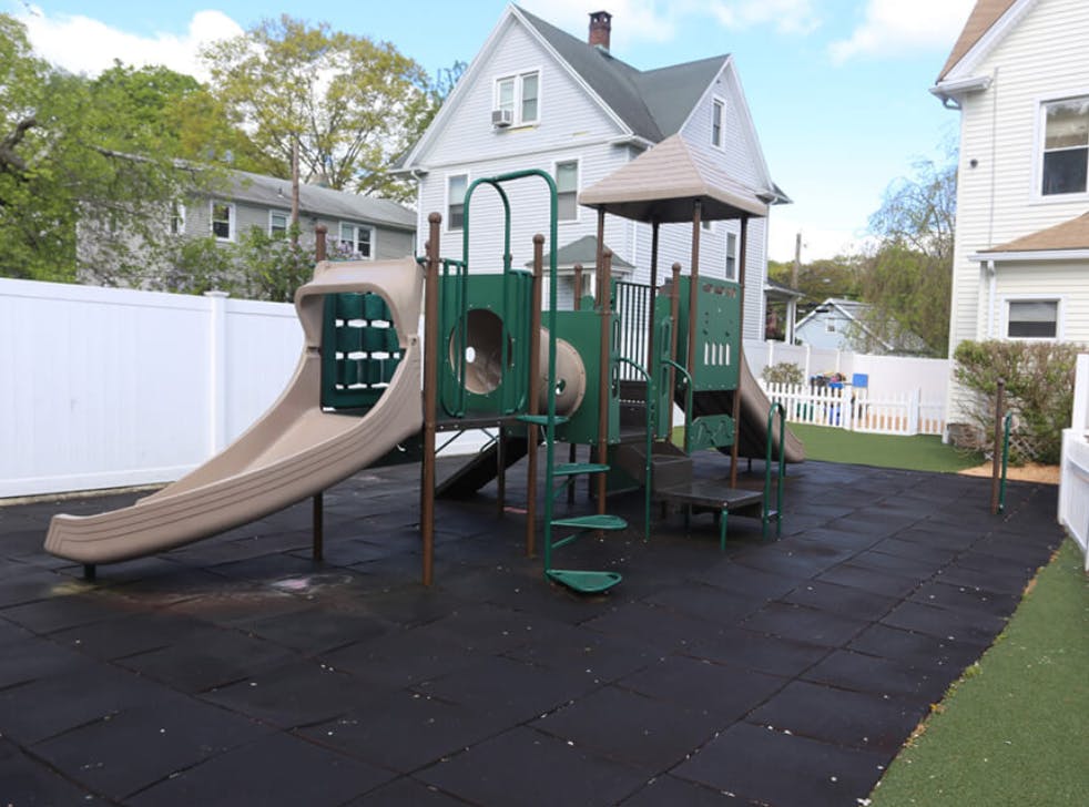 Playground with slides and climbing structures on a dark surface