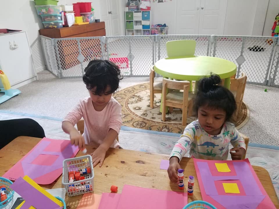 Two children doing crafts at a table