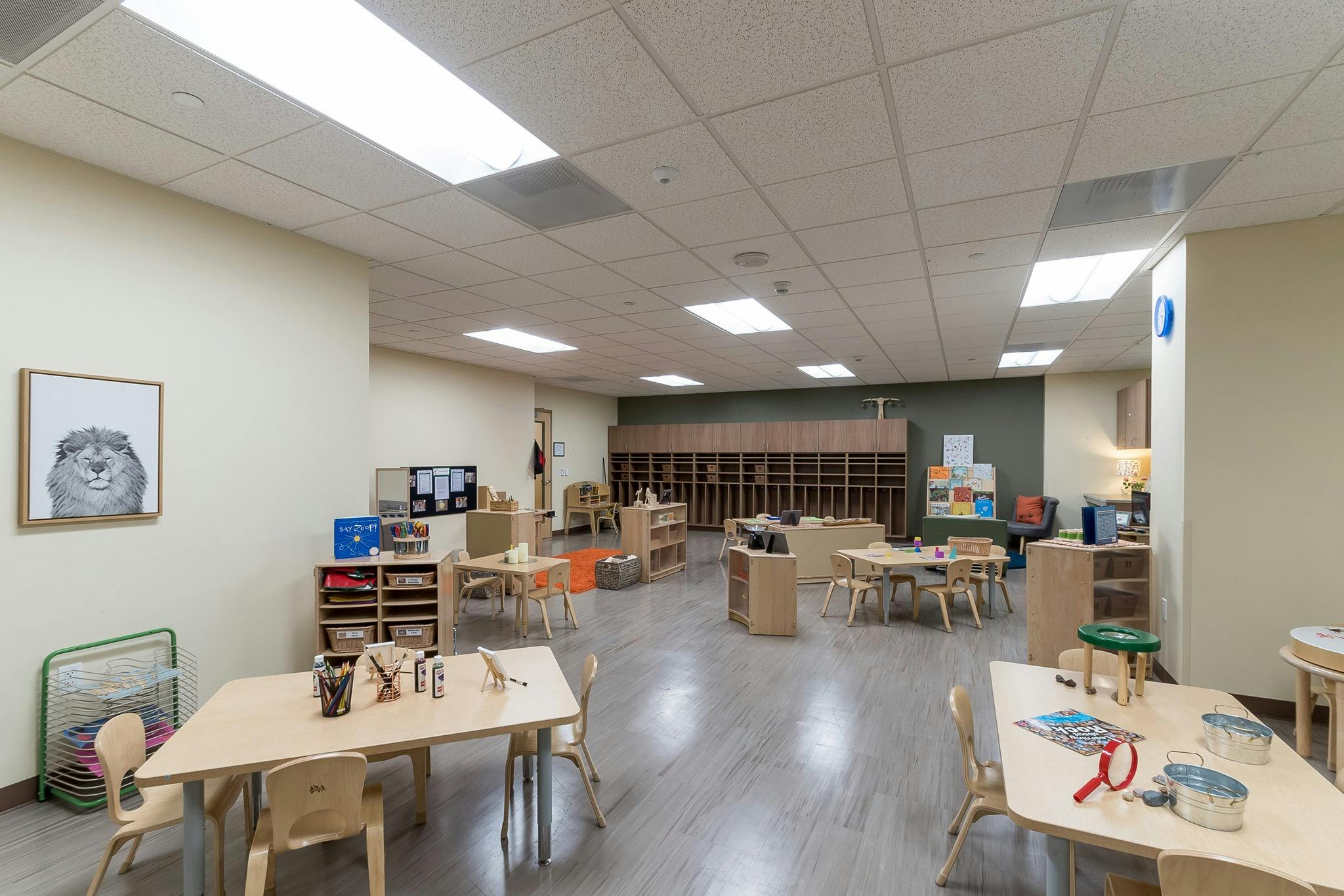 Empty classroom with small tables and chairs