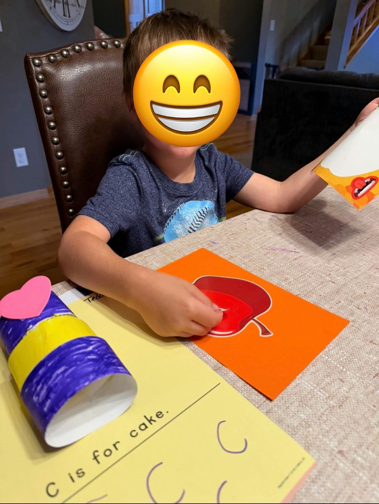 Child sitting at a table working on a paper learning activity