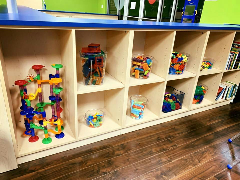 Shelves with various colorful toys and books