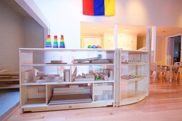 Shelving unit with various wooden blocks and learning materials
